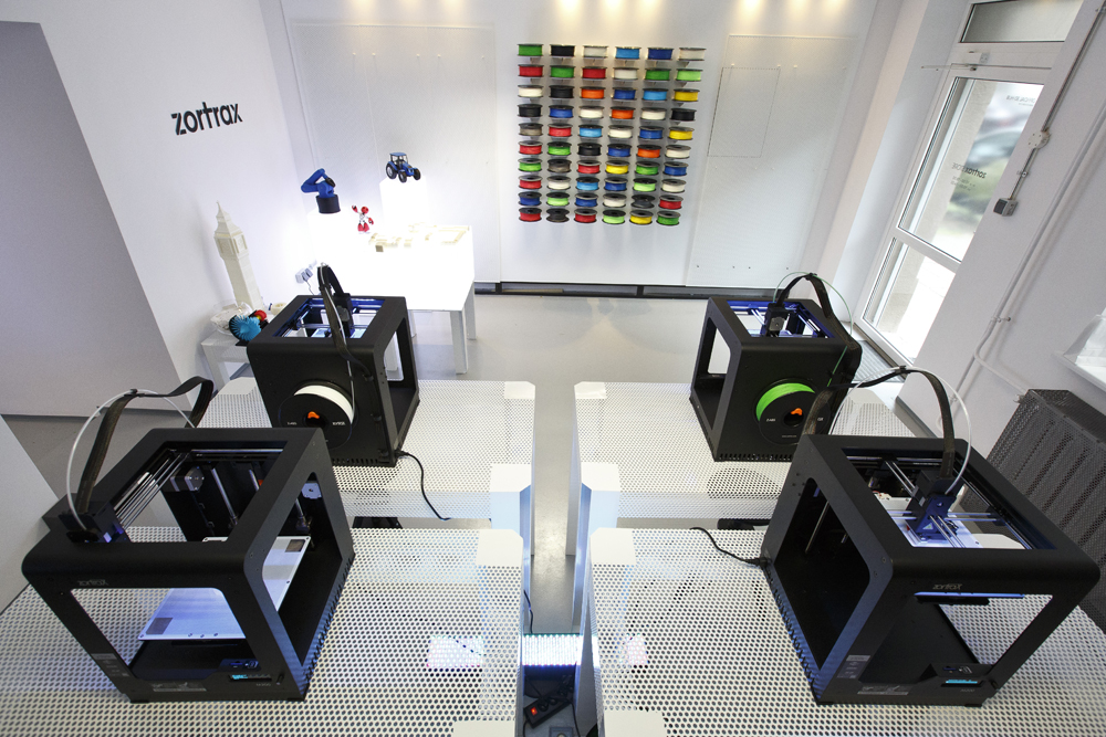 Zortrax 3D printers displayed on custom perforated steel tables